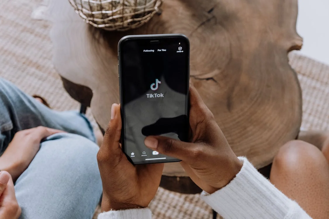 man using tiktok app on phone man using tiktok app on phone
