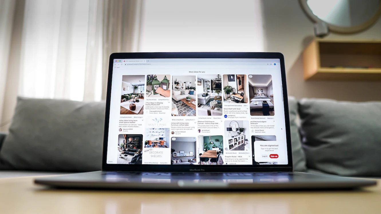 laptop on wooden table showing pinterest Laptop on wooden table showing Pinterest